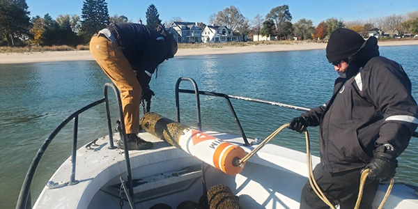 Police Officers removing swim buoys from the water
